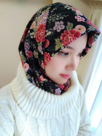 Put the low part of hijab to the turtle neck or simply tie both tips behind the neck